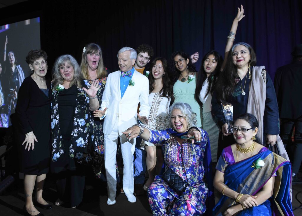 A group of winners cheer and smile on stage at the 2023 Mississauga Arts Awards.