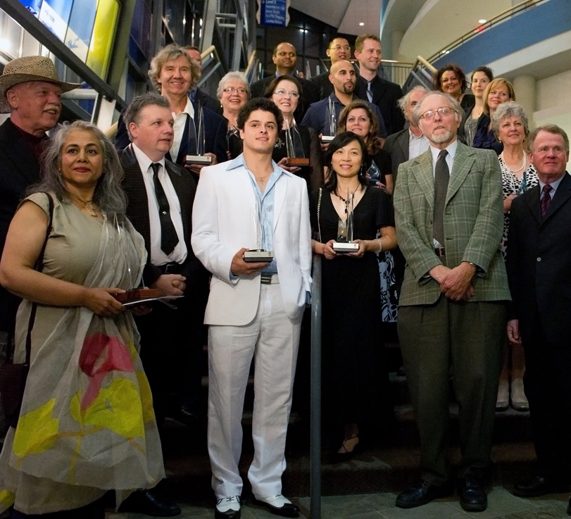 The winners of the 2010 MARTY Awards stand on the staircase of the Living Arts Centre, photographed from a low angle.