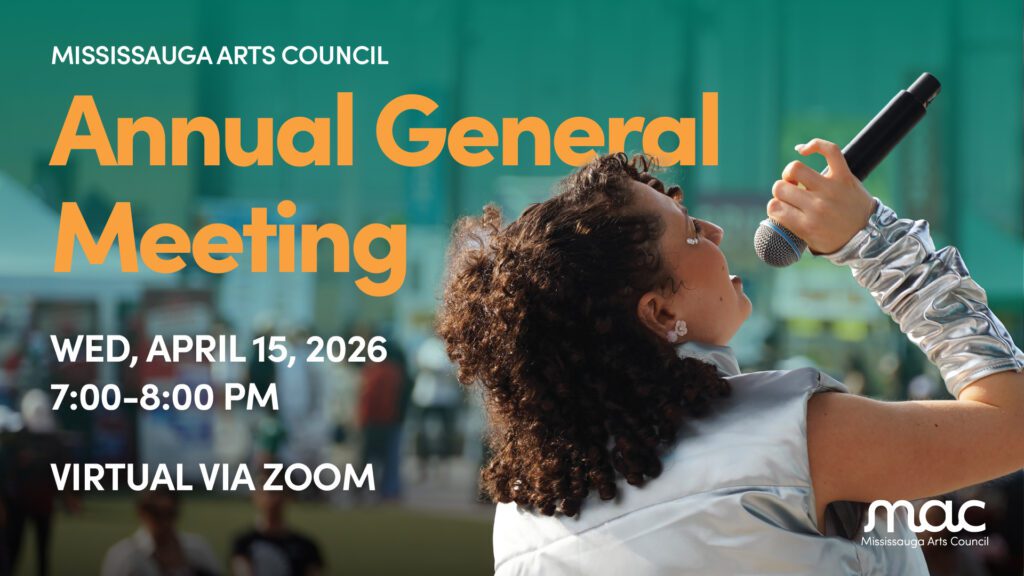 A promotional graphic for the Mississauga Arts Council's Annual General Meeting. On the right, a person with curly hair is shown from the side, singing into a microphone while wearing a silver, metallic sleeve. The background is a soft-focus outdoor setting with green tones. Bold text on the left reads: "MISSISSAUGA ARTS COUNCIL Annual General Meeting, WED, APRIL 15, 2026, 7:00–8:00 PM, VIRTUAL VIA ZOOM." The MAC logo is located in the bottom right corner.