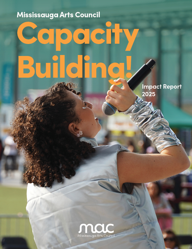 The cover of the Mississauga Arts Council (MAC) 2025 Impact Report. The top of the page features the title "Capacity Building!" in large, bold orange letters. Below it, a person with dark curly hair is shown from the back and side, singing into a microphone while wearing a shimmering silver vest and matching metallic arm sleeve. The background shows a blurred outdoor event space with greenery and people. To the right, text reads "Impact Report 2025," and the MAC logo is centred at the bottom.
