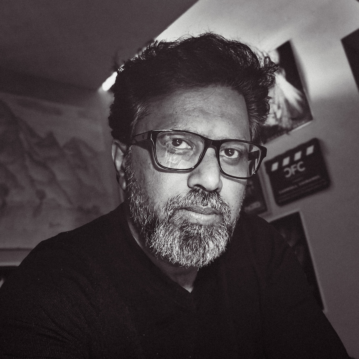 Headshot of Carroll Chiramel in black and white.