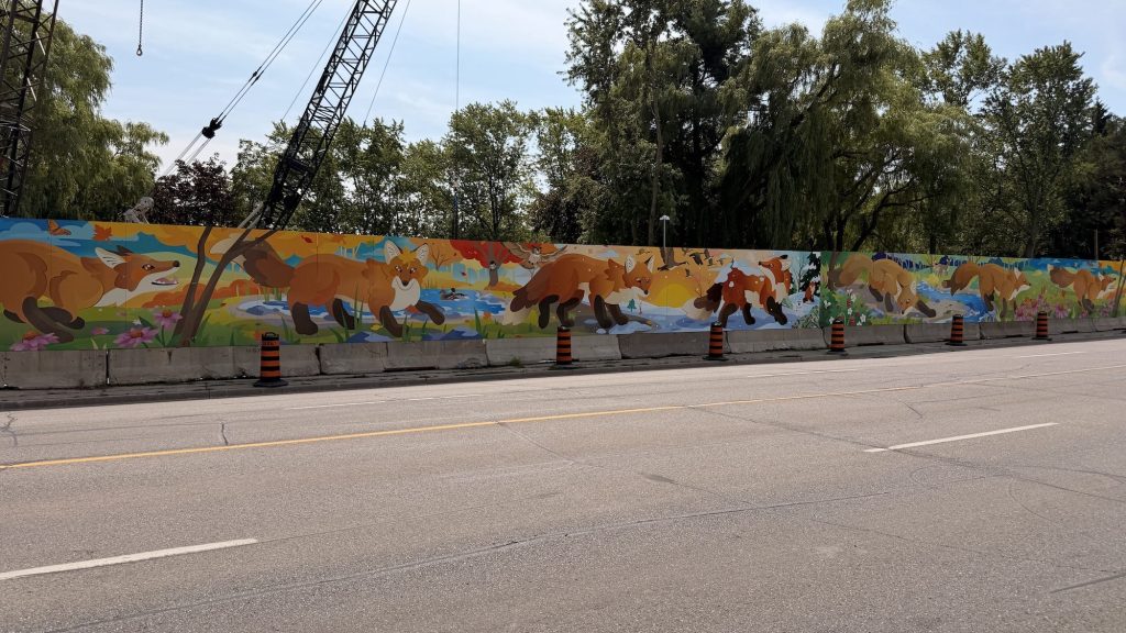 Large scale hoarding mural created by Sauga City featuring foxes running through all seasons.